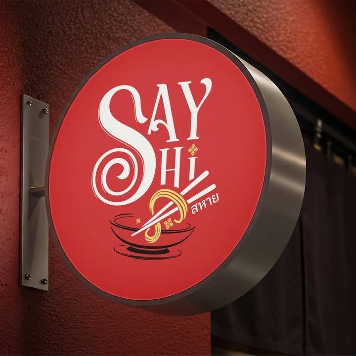 The illuminated round Say Hi sign at the shopfront